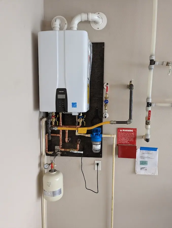 Professional plumber installing copper piping in a Mussey home